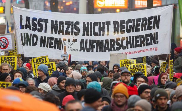 Itävallan hallituskokoonpanoa vastustavien mielenosoittajien bannerissa lukee: "Älkää antako natsien hallita ja marssia".