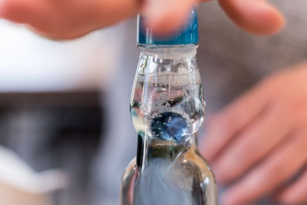 Pullon suulta ”tiputettava” marmorikuula jää pyörimään pullon yläosaan.