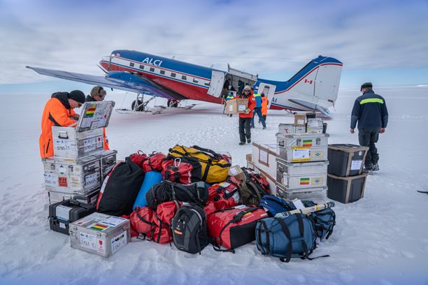 Retkikunta on laskeutunut Basen vuoren jäätikölle, tutkimusasema Aboan läheisyyteen, ja purkavat rahtia ulos lentokoneesta. 