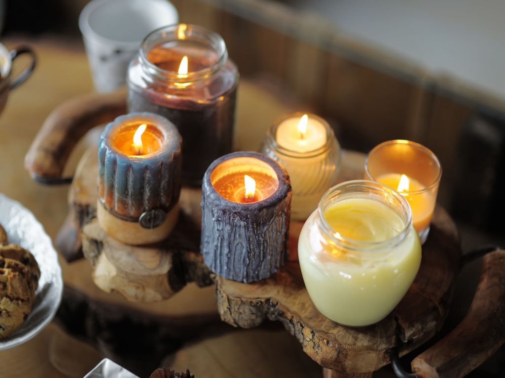 Beautiful ablaze candle on the wooden table 